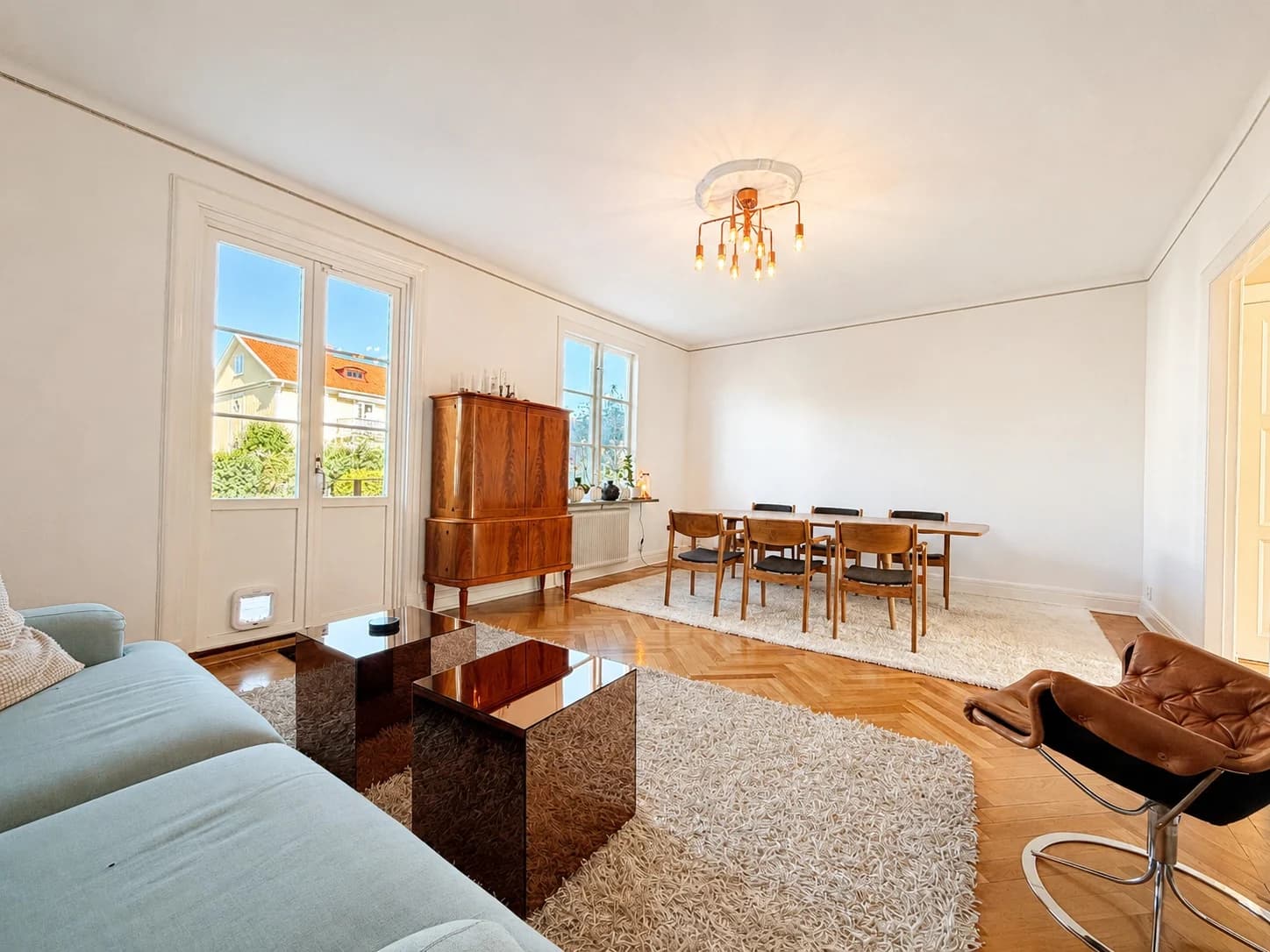 Sofa, dining area and parquet floor